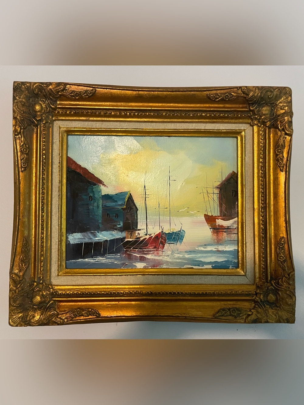 Seaside fishing village painting unsigned in gilded gold frame